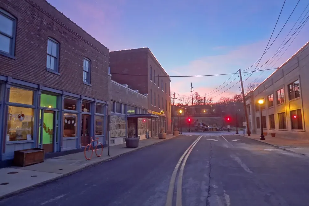 Brick storefront buildings along Church Street under a pink evening sky in Ferguson, Missouri